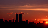 [Setting Sun with Flagpole between Twin Tower Silhuoette]